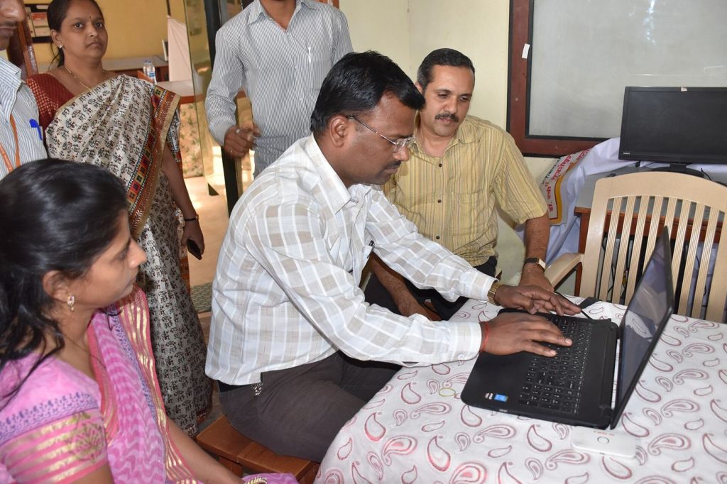 Adults Return to Classrooms for Essential Digital Skills Adults follow a computer training session seated at desks in a bright classroom.