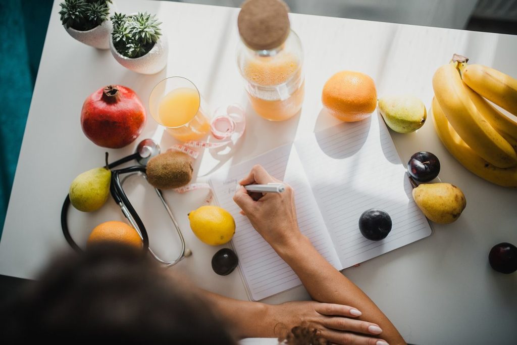 Household Budgets Find Room in the Weekly Check-In notebook and pen on a kitchen table