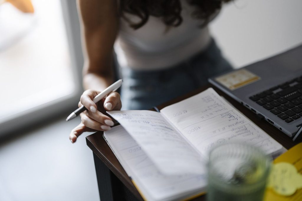 Newsletters Are the New Magazines: Inside the Subscription Writing Boom A writer's desk with a laptop, notebook and coffee